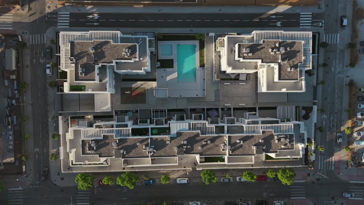 geometric rooftop patterns and pool in sunny spanish housing development