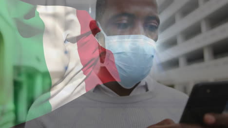 animación de la bandera de italia sobre un hombre afroamericano con máscara facial.