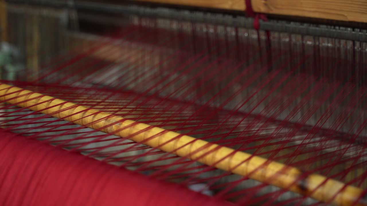 A traditional manual shuttle loom in use at a textile workshop in Morocco, showing artisan weaving techniques