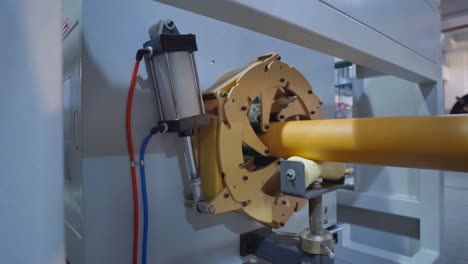 close-up of industrial machinery and plastic pipe production