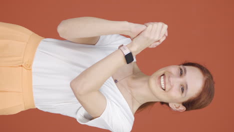 Vertical-video-of-Woman-looking-at-camera-making-confidence-sign.