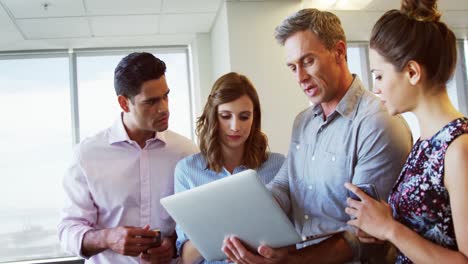 Executives-discussing-over-laptop