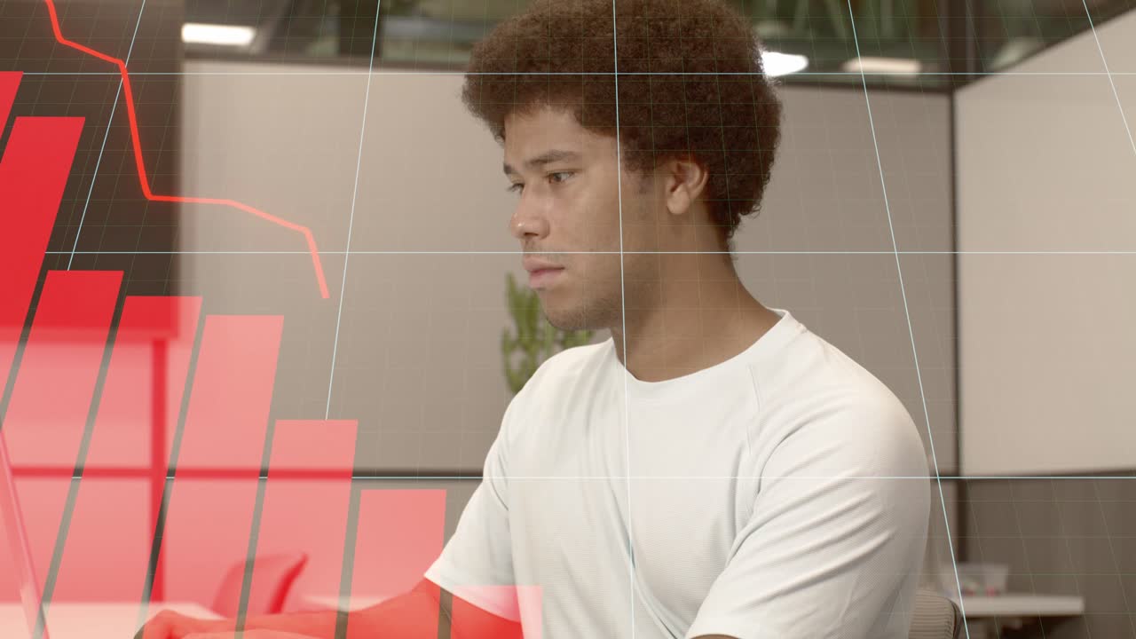 Young Black male adult on a computer with graphic overlay of data charts.