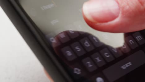 hands typing on a smartphone keyboard