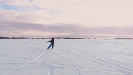 kite surfer being pulled by his kite across the snow