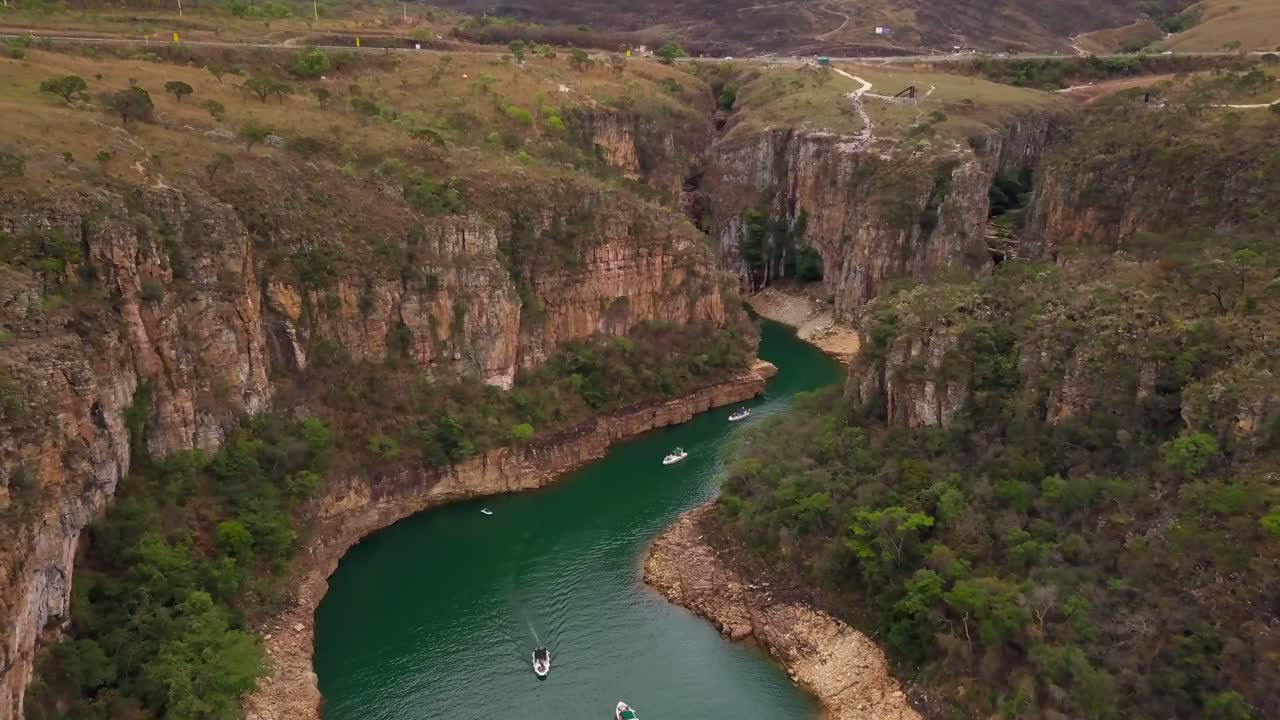 Canyon river with boats and lush cliffs, peaceful nature in Minas Gerais, Brazil