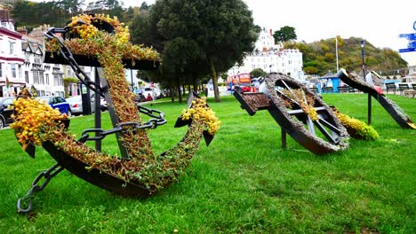 flowery anchor wheel and propeller display making word joy in artistic town garden sculpture