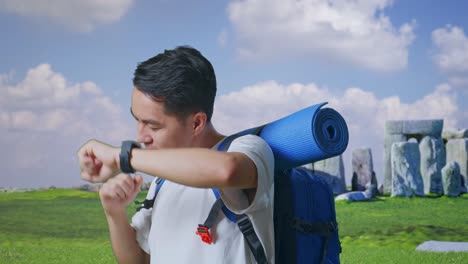 close up of asian male hiker with mountaineering backpack enjoy dancing while traveling in stonehenge