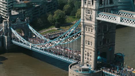 descending pan up reveals tower bridge marathon scene and london skyline beyond