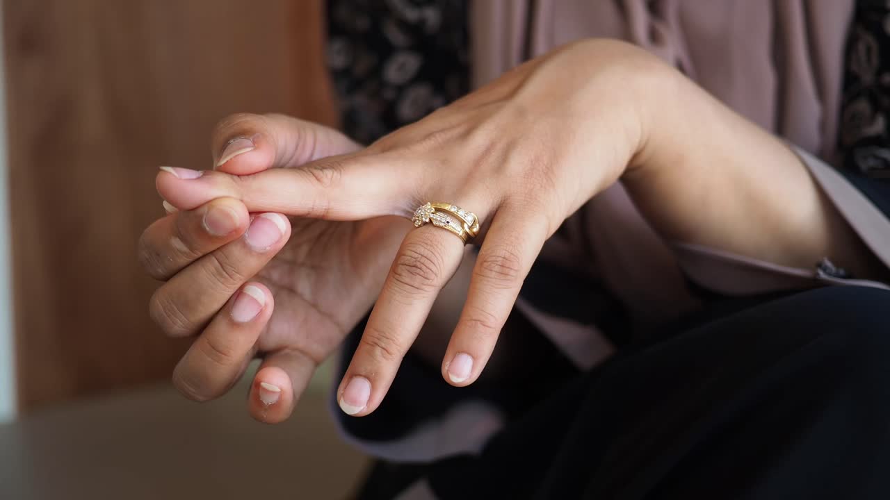 Woman Adjusting Ring on Finger