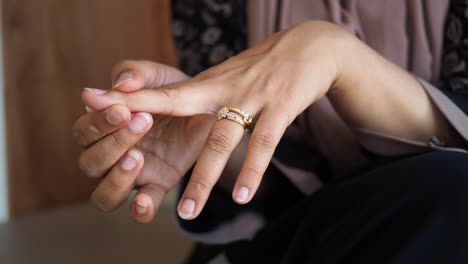 woman adjusting ring on finger
