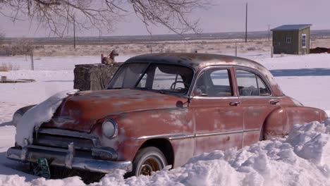 an old abandoned cadillac in atomic city, idaho on a cold winter day