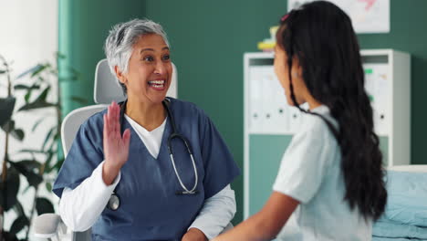 a doctor giving a child a high five