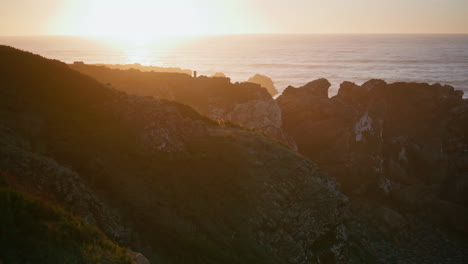 rocky coast golden sunset in tranquil beauty. picturesque ocean shore at dusk