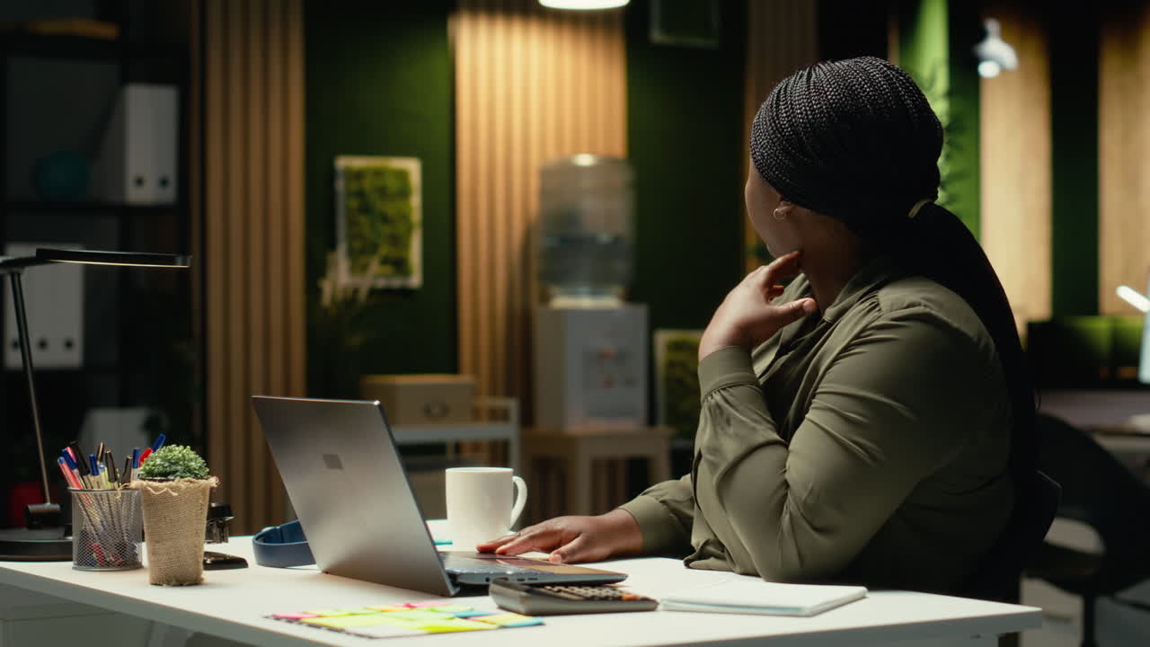 Demotivated businesswoman sighing after realizing the late hour