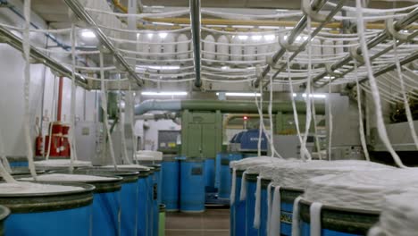barrels of freshly processed fabric at a cotton factory in brazil