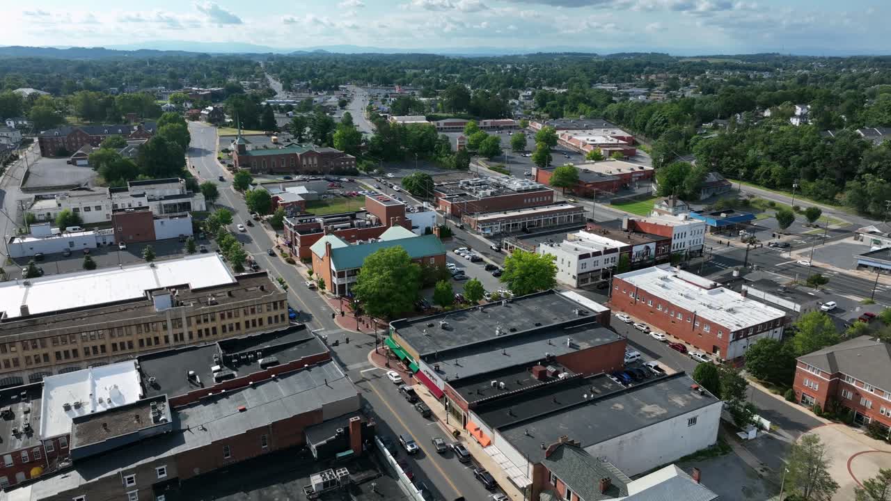 Historic American town ich cars on main streets and square. Red brick buildings on sunny summer day in Virginia state, USA. Aerial top down shot