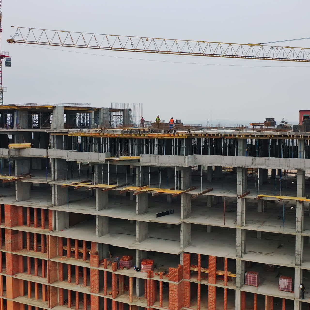 Construction site in a megacity. Video shooting with drone. New house in a residential complex. Motion camera back.