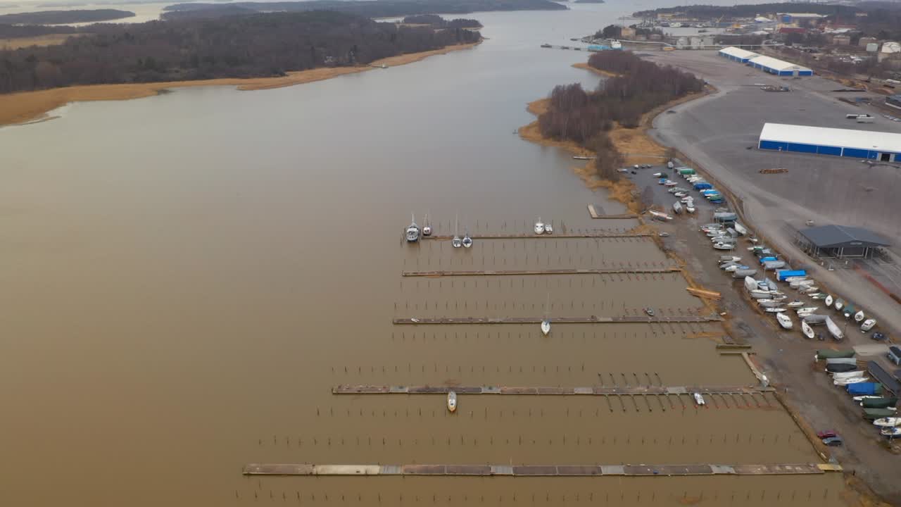 Aerial View of a Marina with Boats and Docks in a Muted Landscape