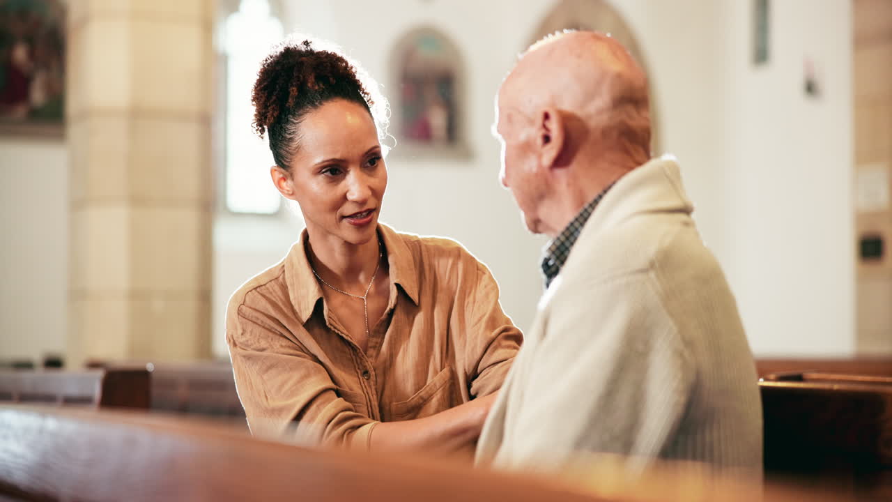 Woman comforting elderly man in church