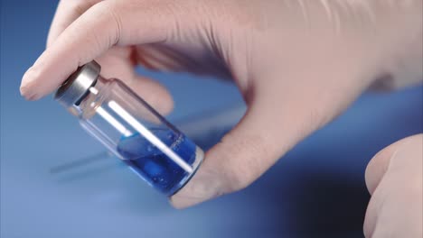 medical professional handling vaccine vial