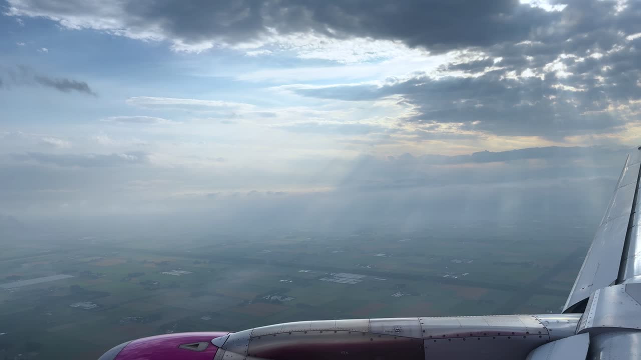 Airplane wing view above clouds, serene sky during flight travel