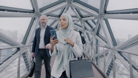 businesswoman using smartphone on a modern city bridge