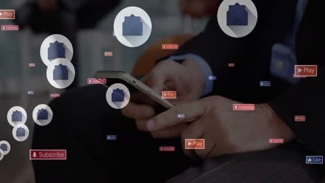 animation of social media icons floating over mid section of a businessman using smartphone