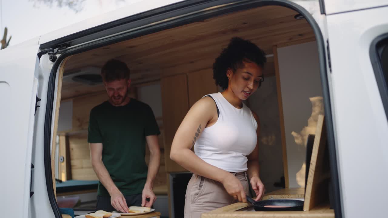 Couple cooking in a van