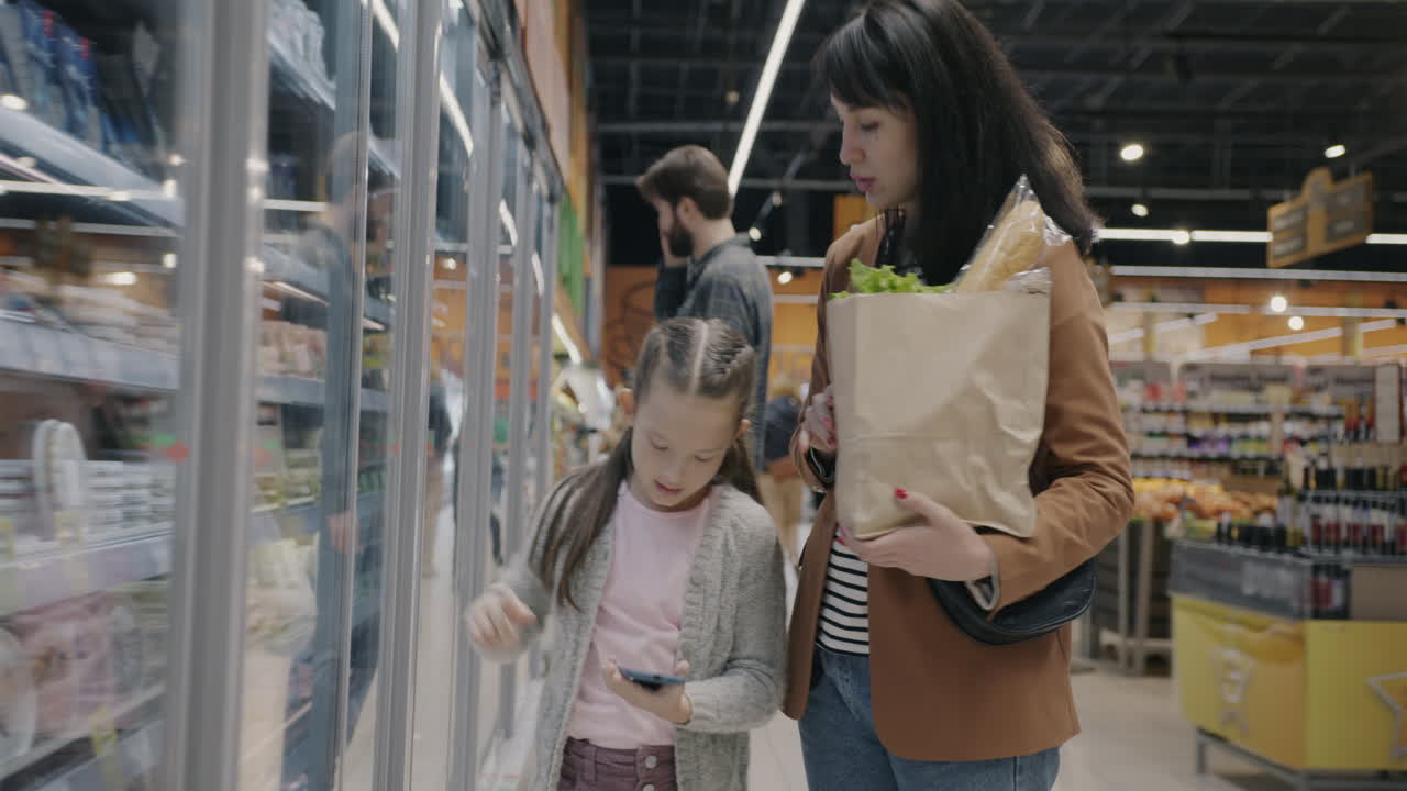 Mother and daughter shopping at the supermarket