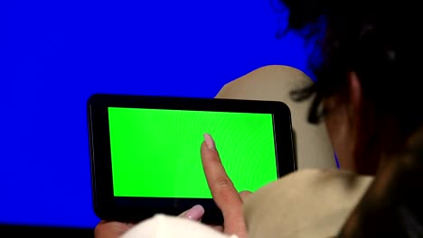 girl using tablet pc with green screen. uhd stock video, alpha matte included