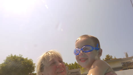 a boy and grandmother in the pool