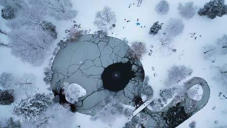 People-Walking-Near-Frozen-Pond-During-Winter-Season-At-Wright-Park-In-Tacoma,-Washington,-USA