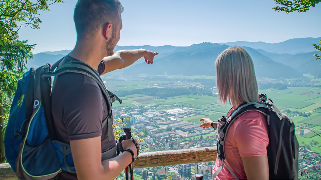 Hiker Couple Point At Radlje ob Dravi, Slovenia From Panoramic Viewpoint