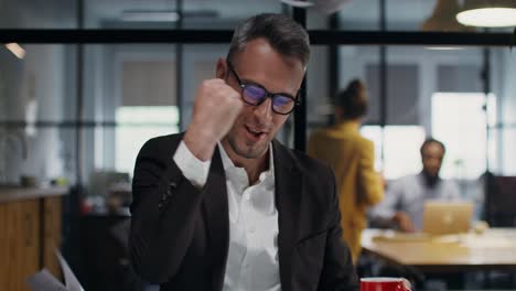businessman reacts to documents/coffee break in office