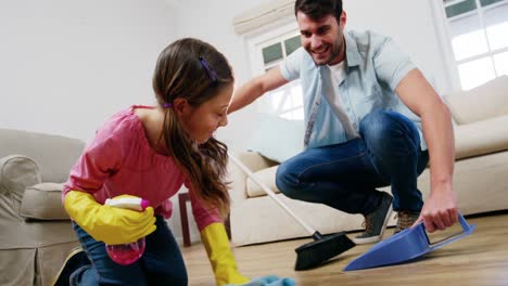 daughter helping father to clean floor