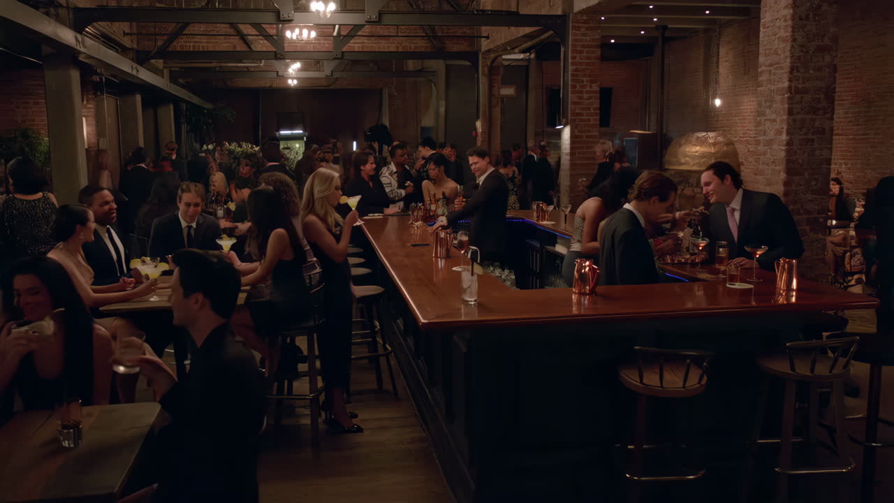 People socializing and enjoying drinks at a lively bar event