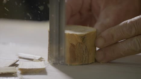Close Shot Of Wood Artisan Cutting Carefully Little Piece Of Trunk