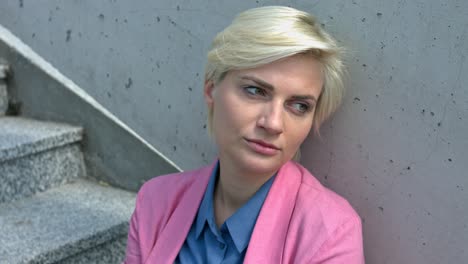 sad business woman in depression sitting on the concrete stairs