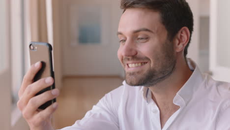 happy young man having video chat using smartphone looking surprised enjoying good news chatting on mobile phone