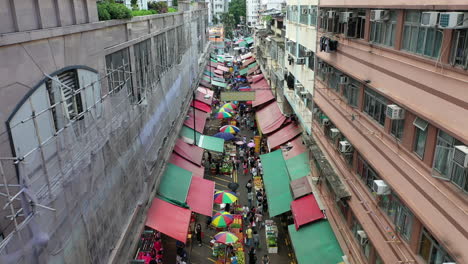 food market with crowd of people in a narrow street in hong kong