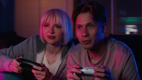 Young-caucasian-couple-playing-video-game-with-game-pads