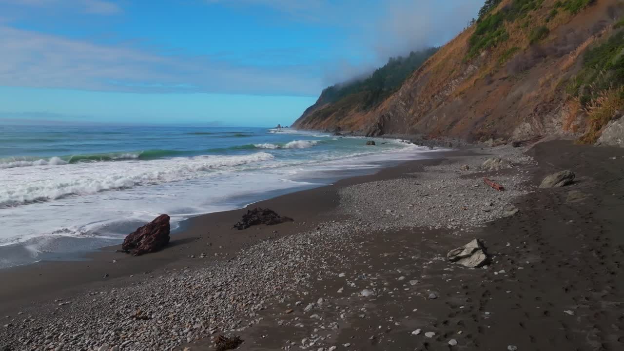 Waves Crashing black sand rugged coastline sunny morning blue sky mist fog layer USAL Beach Campground Lost Coast Trail Californi Pacific Ocean PNW Nor Cali boulders rocks mountainside static motion