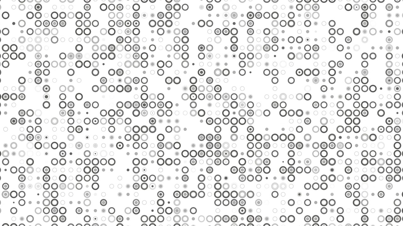 A high angle view of an abstract monochrome background featuring a pattern of varied grey and white concentric circles and dots distributed across a clean white surface. Loop animation.