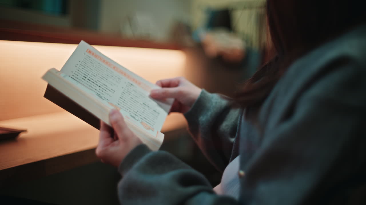 Woman reading a book indoors