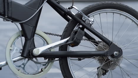 close up black bicycle part standing on empty street. healthy lifestyle concept.