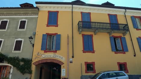 vibrant buildings and parked cars in barolo