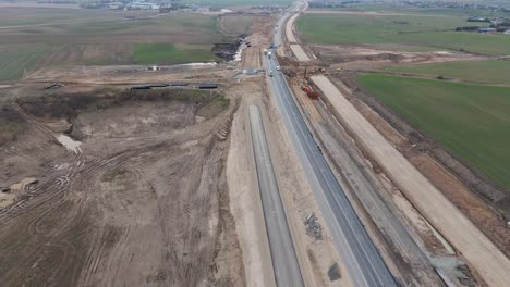 drone shot of the road under construction for the expansion project, there is a construction site with the equipment for work