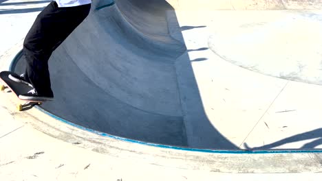 male skater make turns in ramp in wooden skatepark, wide angle view in slow motion