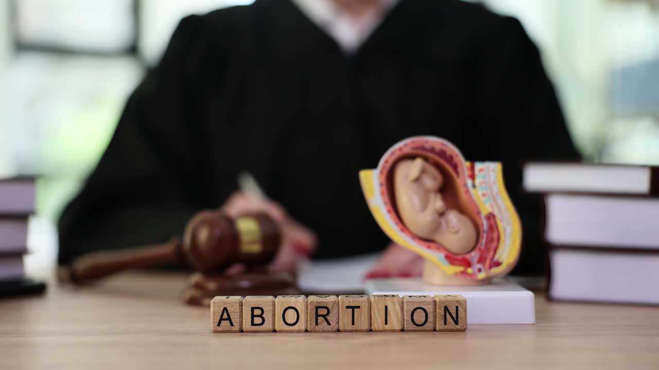 Legal concept of abortion with judge, gavel, and fetal model